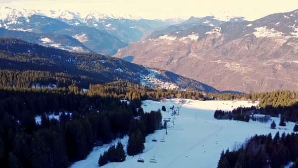 çAerial Winter Scene of Alpine Snowy Mountain Peaks and Dark Spruce Forest in Snow