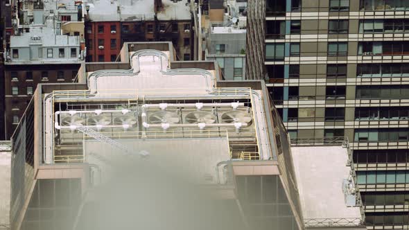 Fans of Air Conditioning System Spinning on Roof Top of Skyscraper New York alt
