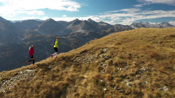 Aerial View Trail Running Couple on Mountain Ridge alt