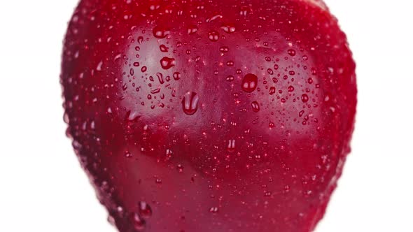 Juicy Red Apple with Water Drops Turns Left Side on White alt