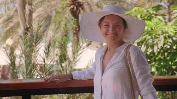 Portrait of the Happy Young Woman Looking and Smiling on the Camera at Vacation