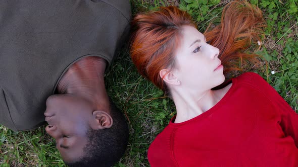 lack of communication.Interracial couple lying  turning head in opposite side alt