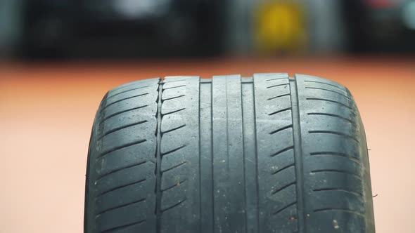 Wheel From the Car on the Background of Workshop alt