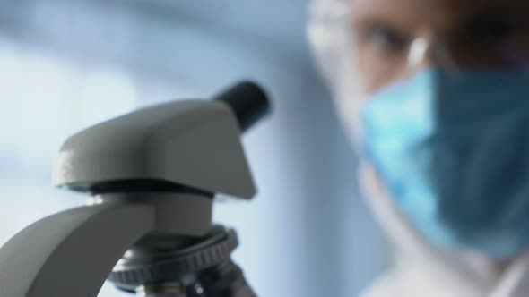 Technician Examining Chip, Using Microscope to Run Diagnosis and Upgrade Device alt