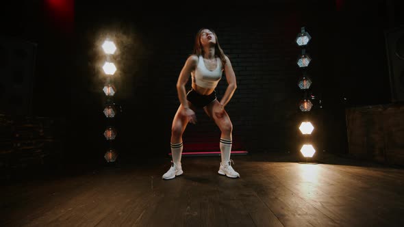 Pretty Brunette Dancing Twerk In Studio With Flashing Light alt