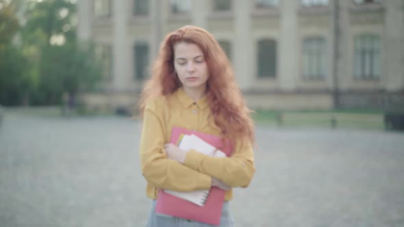 Group of Cheerful College Students Passing Camera Leaving Lonely Redhead Beautiful Woman Standing By alt