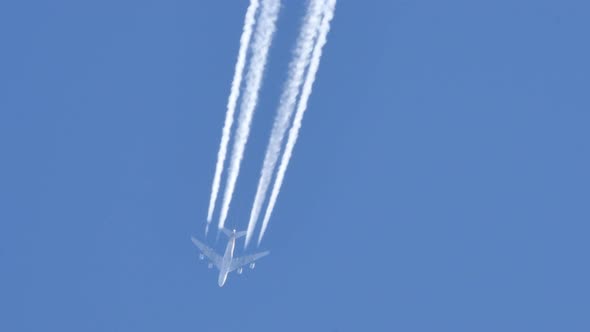 Contrails of a Four Engines Jet Airliner alt