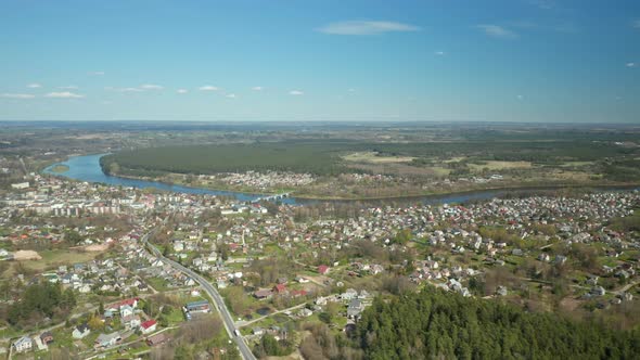 AERIAL: Prienai City with Nemunas Loops in Background on Sunny Spring Day