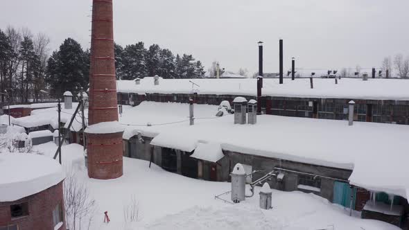 Brick Facade of the Industrial Building Against the Background of the Winter Landscape