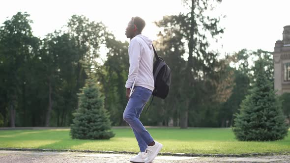Wide Shot Happy Confident African American Student in Headphones Listening to Music Dancing in Slow alt