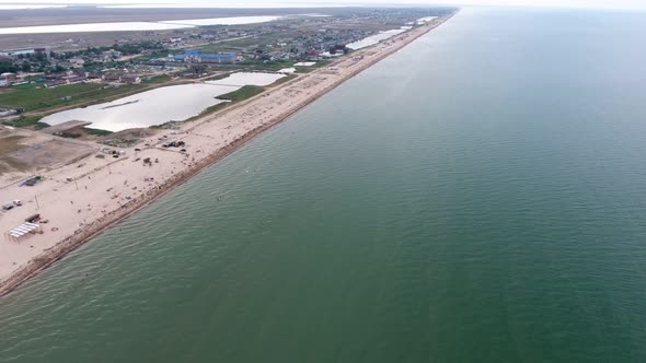 Aerial of Straight Black Sea Seafront with Lonely People, Lakes, and White Sand
