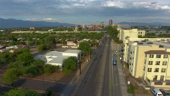 Drone shot following the Sun Link streetcar in Tucson Arizona, rotating and rising alt