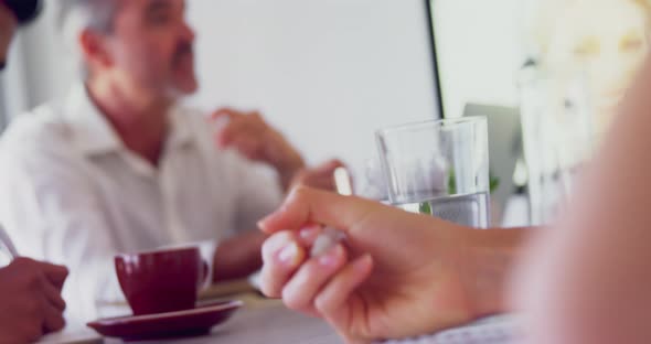 Executives applauding their colleague while giving presentation in office 4k alt