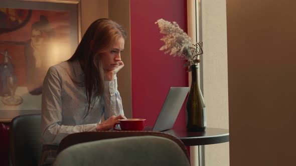 Young Woman Working Remotely in a Cafe