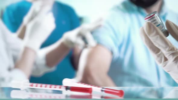 A Nurse is Injecting a Vaccine to a Patient in the Clinic alt