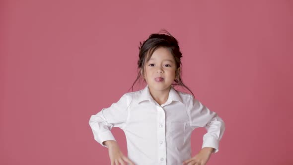 Cute Little Child Girl in White Shirt Shows Different Emotions on Pink Background.