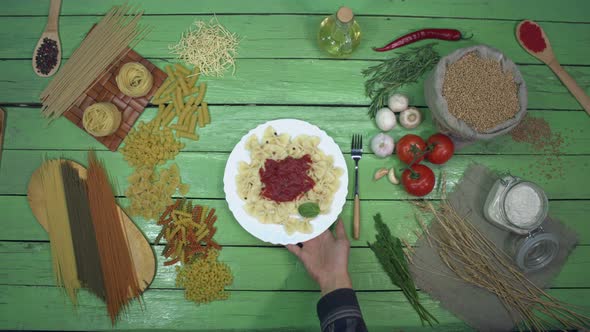 Cooked Pasta on Plate with Tomato Sauce. alt
