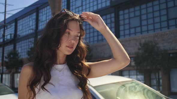 Smiling Woman Wearing Sunglasses on Street alt