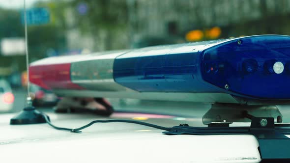 Flashing Flasher on the Roof of a Police Car. Blinker. Close-up. alt