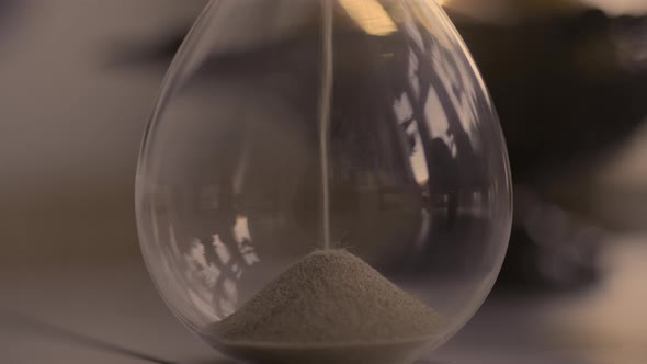 Hourglass sand falling in slow motion alt