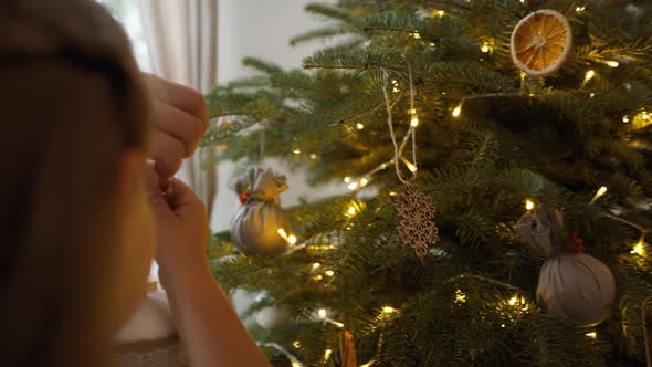 Father and daughter decorating the Christmas tree. Shot with RED helium camera in 8K alt
