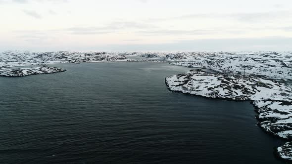The Drone Flies in the Bay of the Arctic Ocean to the Rocky Shores