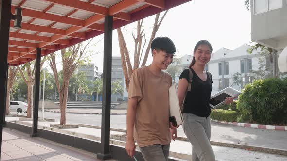 Education and student concept. Happy students walking on walkway.