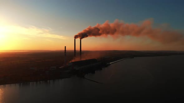 Aerial Drone View: High Chimney Pipes with dirt smoke from Coal Power Plant. alt