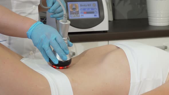Cropped Shot of a Female Client Receiving Rf-lifting Treatment on Her Stomach