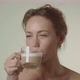 Young Woman Smiling And Taking A Drink Of Coffee - VideoHive Item for Sale