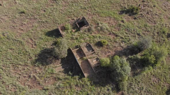 AERIAL Circling Old Ruins in a Green Field Late Afternoon alt