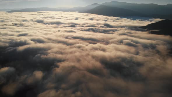 Aerial Shot Flying Above Amazing Fluffy Clouds at Morning Time