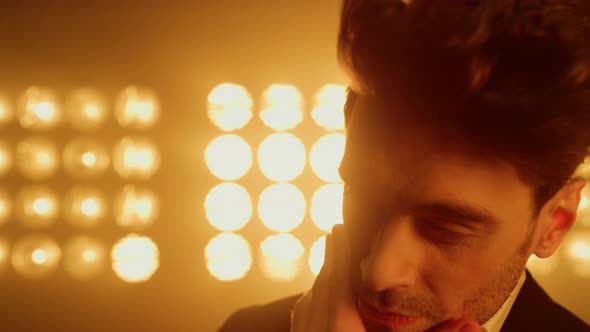 Sexy Man Touching Face Looking Camera on Stage Close Up alt