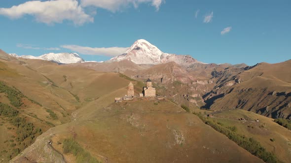 Gergeti Trinity Church in Stepantsminda Mountain Kazbegi at Background Georgia alt