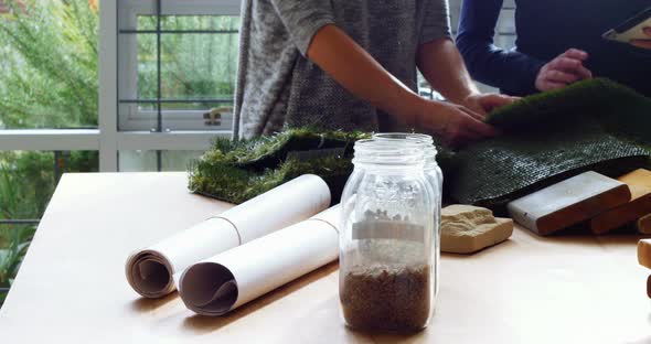 Business executives discussing about artificial turf alt