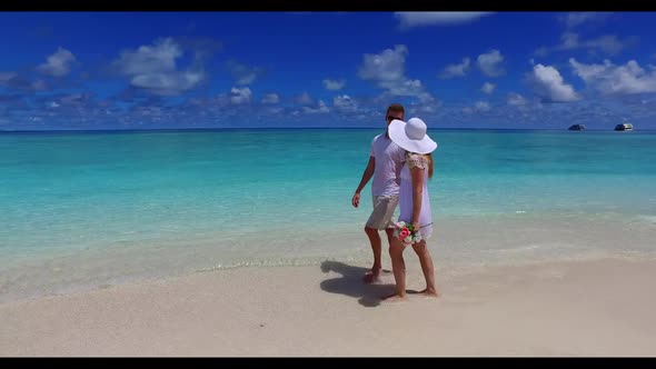 Boy and girl tan on luxury tourist beach lifestyle by blue water and white sand background of the Ma alt