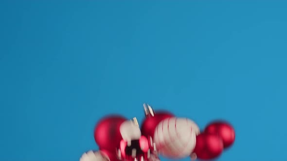 Flying Christmas Balls Against Blue Background