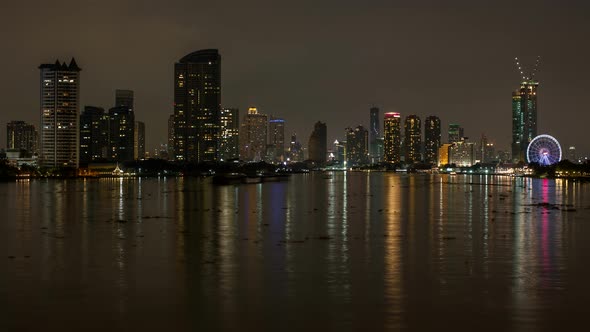 Calm Dark Night Scenery at Bangkok Chao Phraya River with Boats, Skyscrapers and Skyline alt