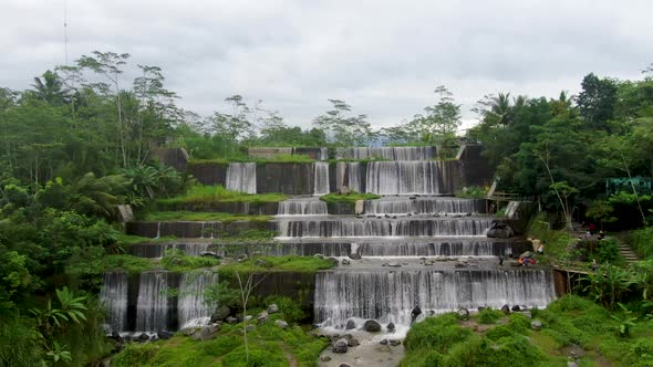 Aerial forward drone view of Watu Purbo waterfall in Muntilan, Indonesia alt