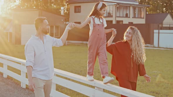 Parents Walking Girl on Fencing alt