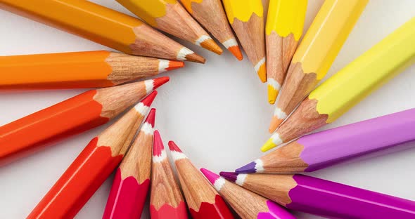 Creative layout made of colored wooden pencils on a white background
