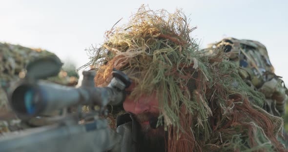 Soldier Lies on the Ground and Patrols the Area From Concealment Opens the Flap of Binoculars Looks alt