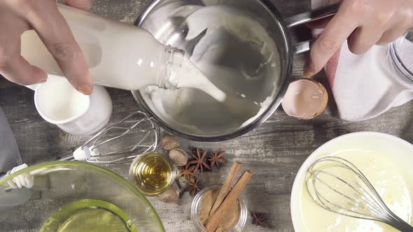 Slow Motion Pour the Milk Into a Saucepan Out of the Bottle Top View