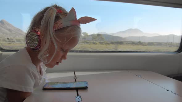 Kid Watching Mobile Video During the Train Ride