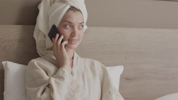 Woman Making Phone Call in Bed alt