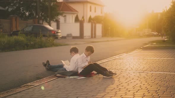 students sitting on road prepare for exam against sunlight alt