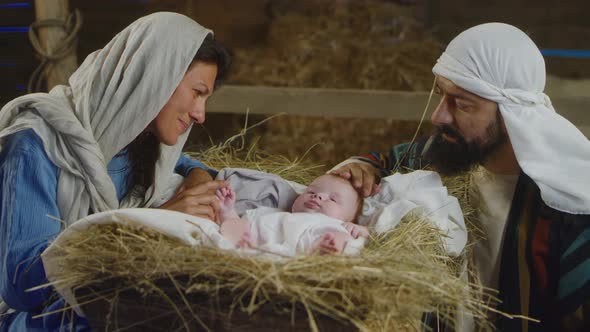 Mary And Joseph Speaking With Baby Jesus In Manger, Stock Footage 