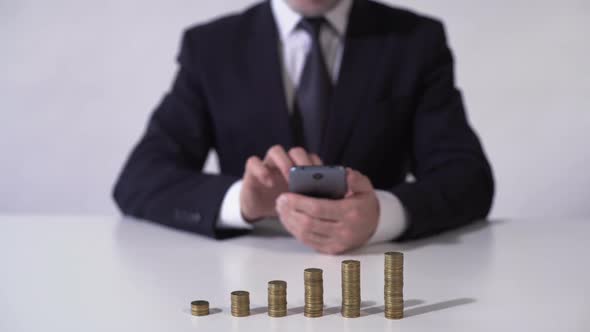 Wealthy Man Checking News on Gadget, Financial Income From Investment Growing alt