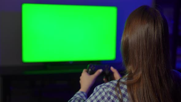 A Young Woman is Playing a Game Console