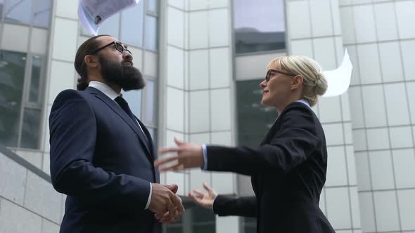 Female in Business Suit Throwing Documents and Looking at Man, Relieving Stress